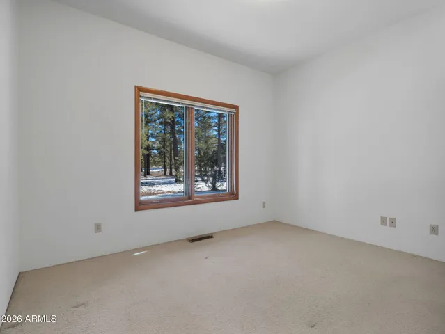 a kitchen with white cabinets a sink and a window