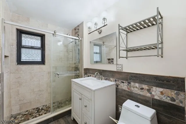 a bathroom with a sink a toilet and shower