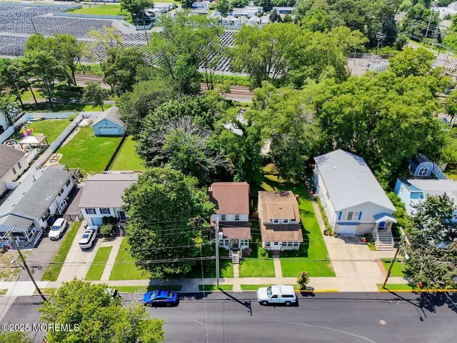 an aerial view of a houses with swimming pool and outdoor space