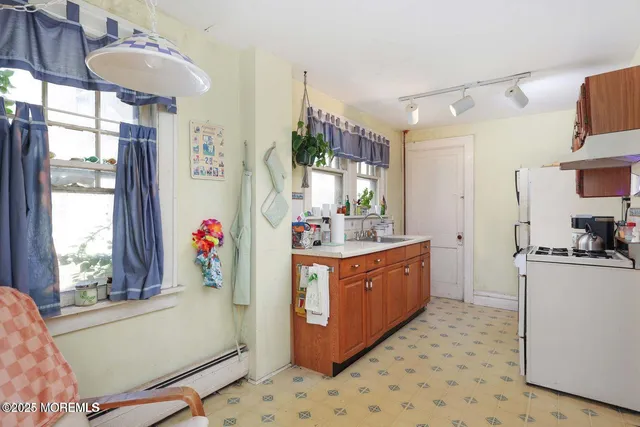 a kitchen with stainless steel appliances granite countertop a sink a stove and a refrigerator