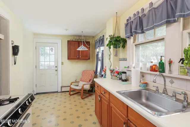 a kitchen with a sink stove and cabinets