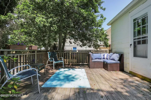 a view of a deck with wooden floor and seating space