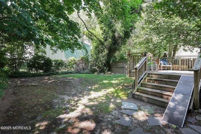 a view of outdoor space with deck and yard