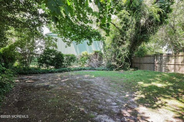 a view of a backyard with large trees