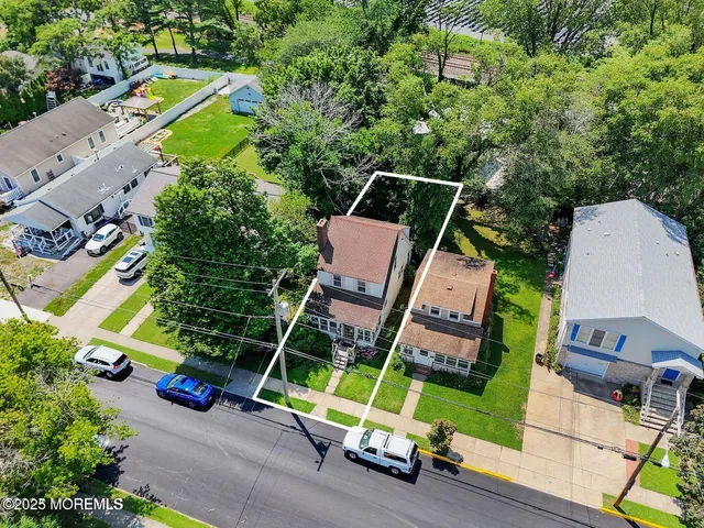 an aerial view of a house with a garden and trees