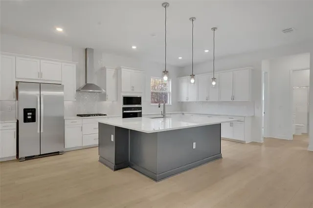 a view of kitchen with stainless steel appliances sink refrigerator and window
