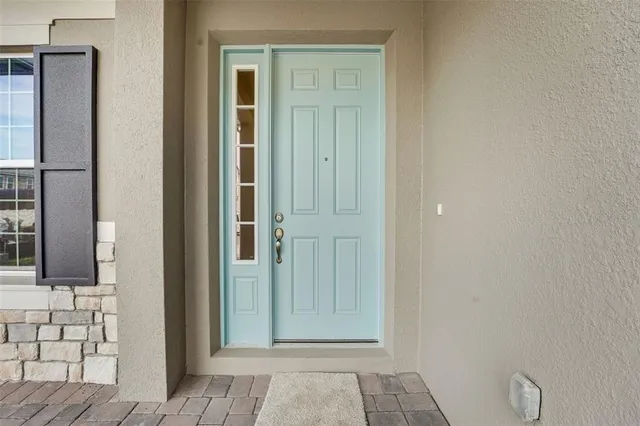 a view of a livingroom with wooden floor and bathroom space