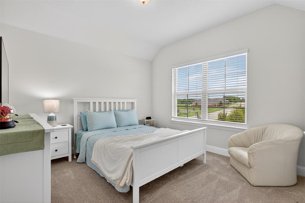 1002 Coppersmith Way Forney, TX 75126 - Photo 22 of 39 a bedroom with a bed and a couch