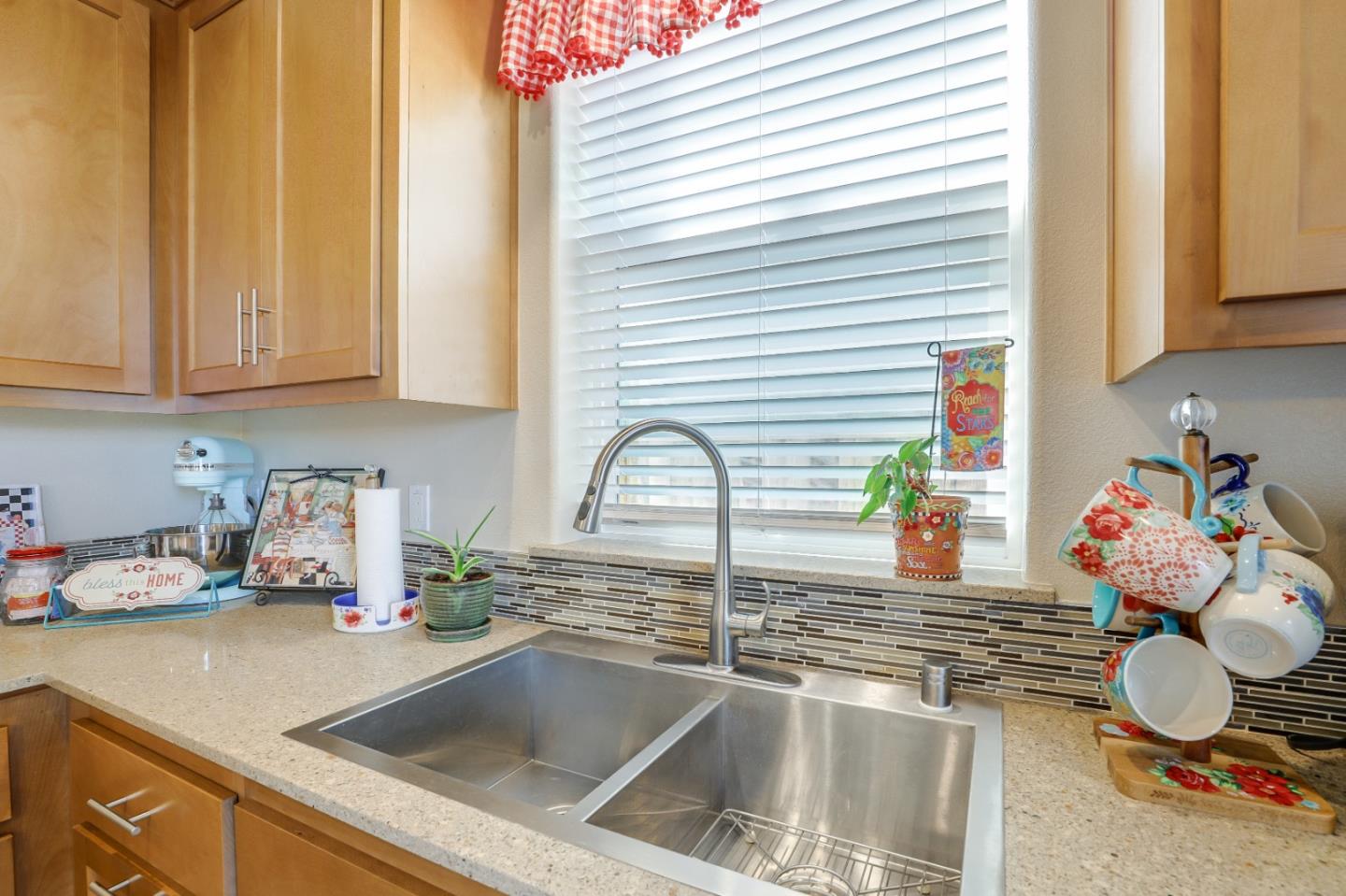260 Springtime Circle Hollister, CA 95023 - Photo 14 of 46 a kitchen with a sink and a white wooden cabinets