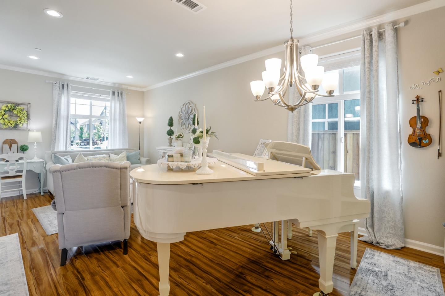 260 Springtime Circle Hollister, CA 95023 - Photo 22 of 46 a dining room with furniture a chandelier and wooden floor