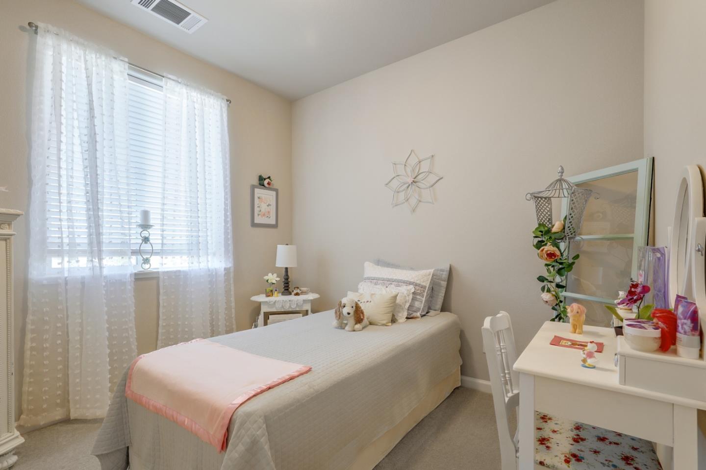 260 Springtime Circle Hollister, CA 95023 - Photo 26 of 46 a bedroom with a bed and a table in it