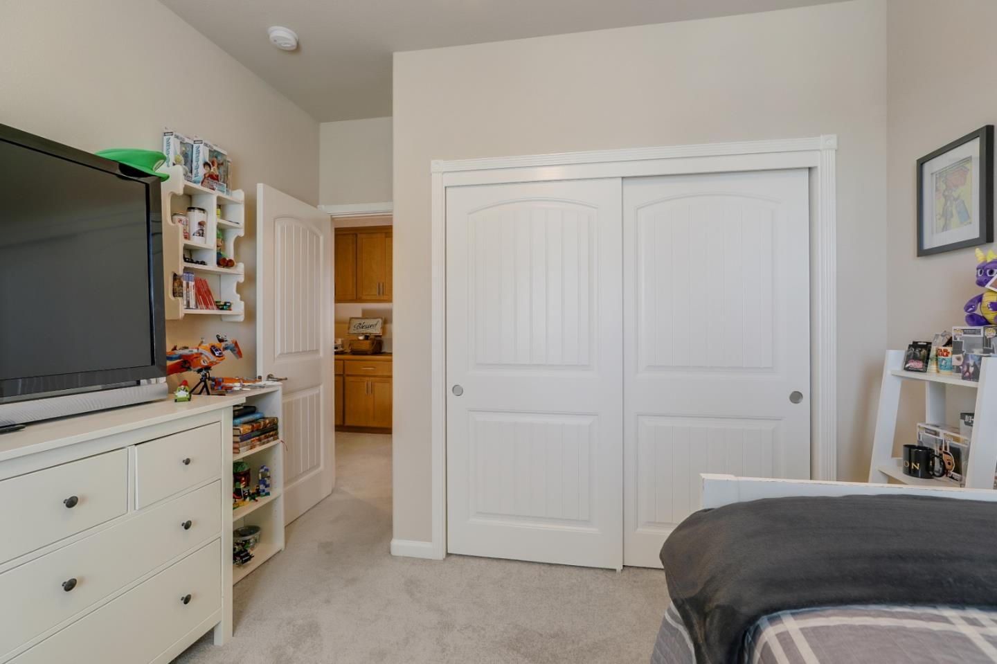 260 Springtime Circle Hollister, CA 95023 - Photo 32 of 46 a bedroom with a bed and a flat tv screen on dresser
