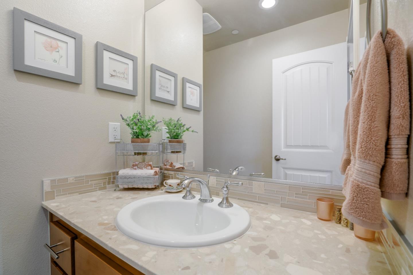 260 Springtime Circle Hollister, CA 95023 - Photo 37 of 46 a bathroom with a granite countertop sink and a mirror