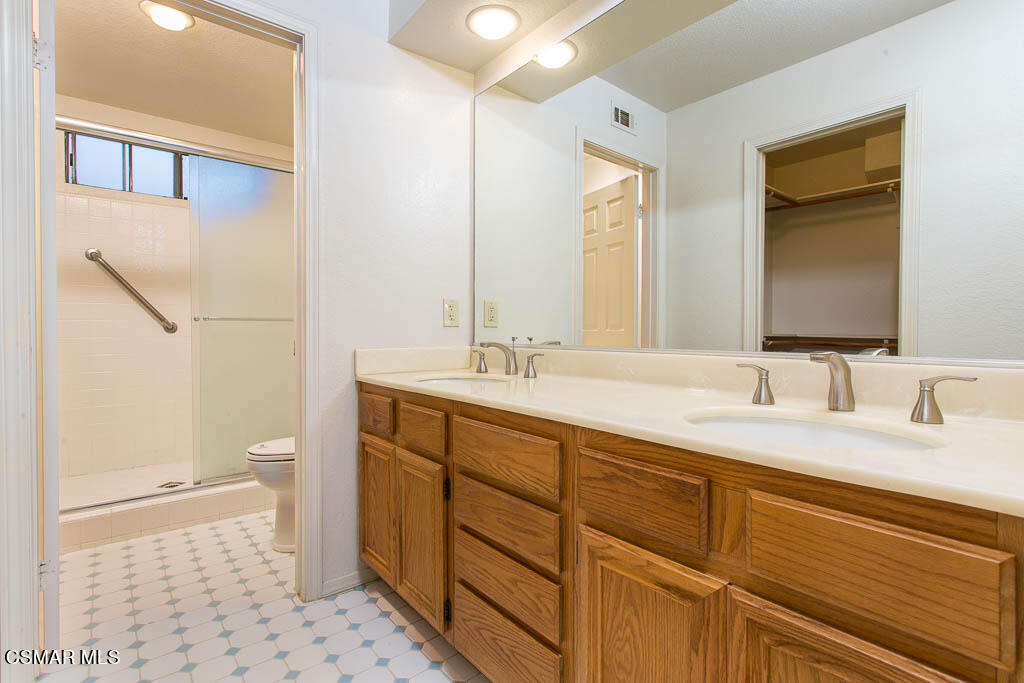 753 Congressional Road Simi Valley, CA 93065 - Photo 12 of 37 a bathroom with a double vanity sink and a mirror