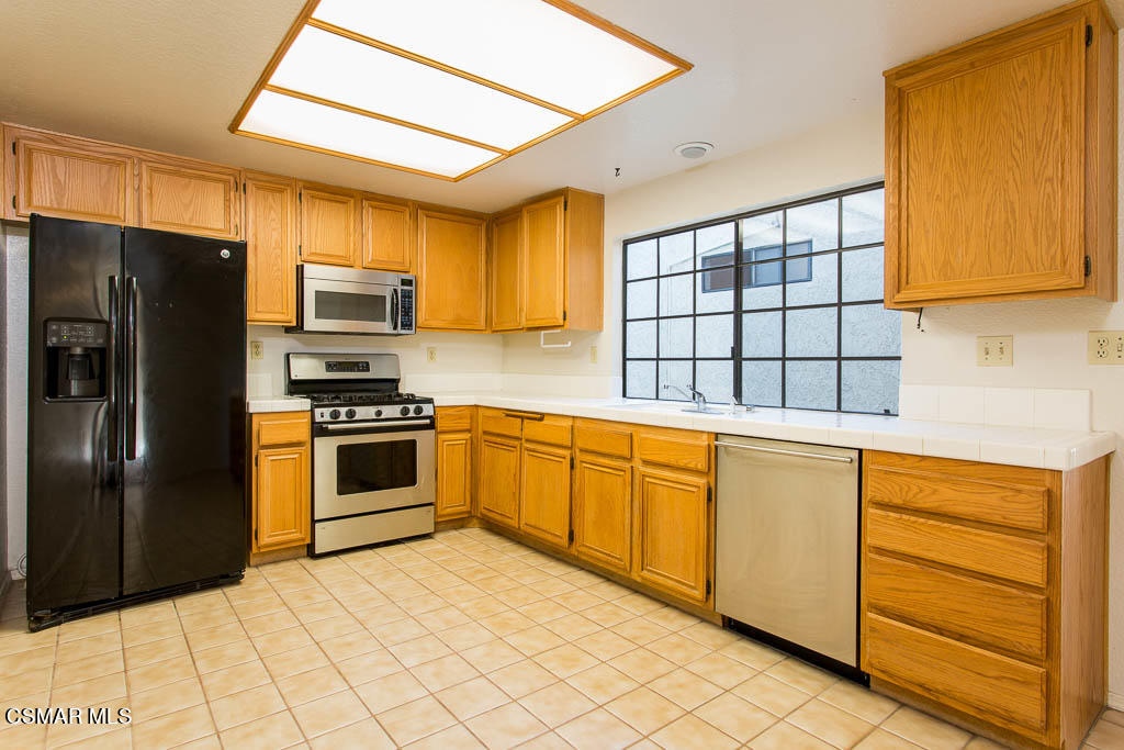 753 Congressional Road Simi Valley, CA 93065 - Photo 6 of 37 a kitchen with stainless steel appliances granite countertop a refrigerator and a sink