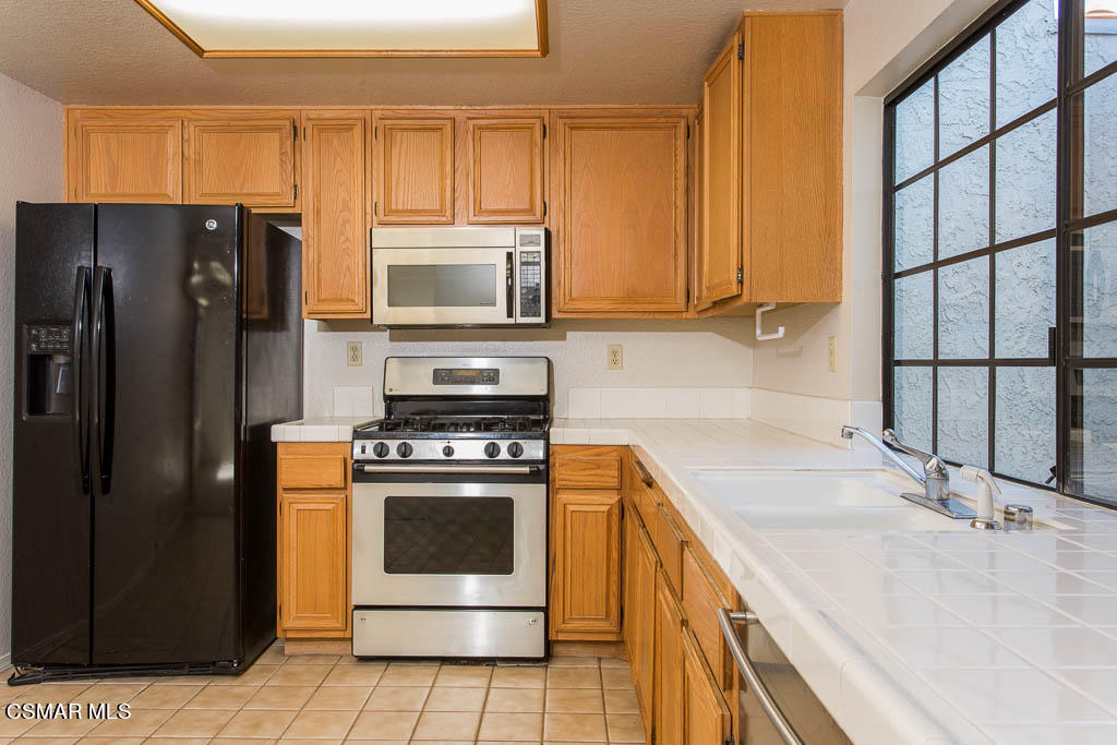 753 Congressional Road Simi Valley, CA 93065 - Photo 8 of 37 a kitchen with a sink stove and refrigerator