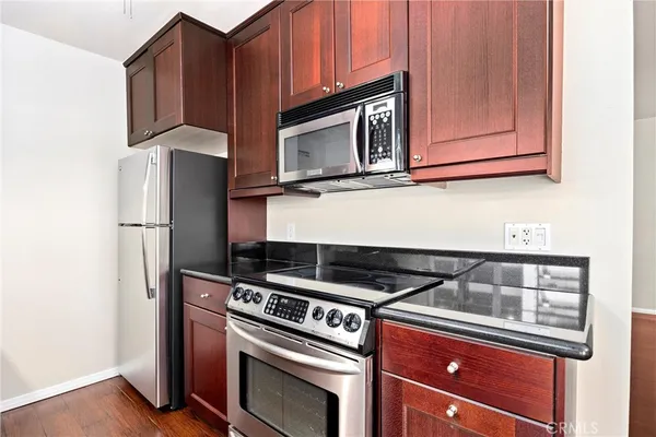 a kitchen with wooden cabinets and a stove top oven