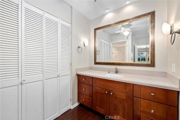 a bathroom with a granite countertop sink vanity and mirror