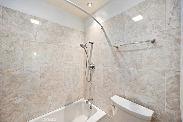 a bathroom with a toilet and shower