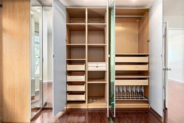 a view of walk in closet with empty racks