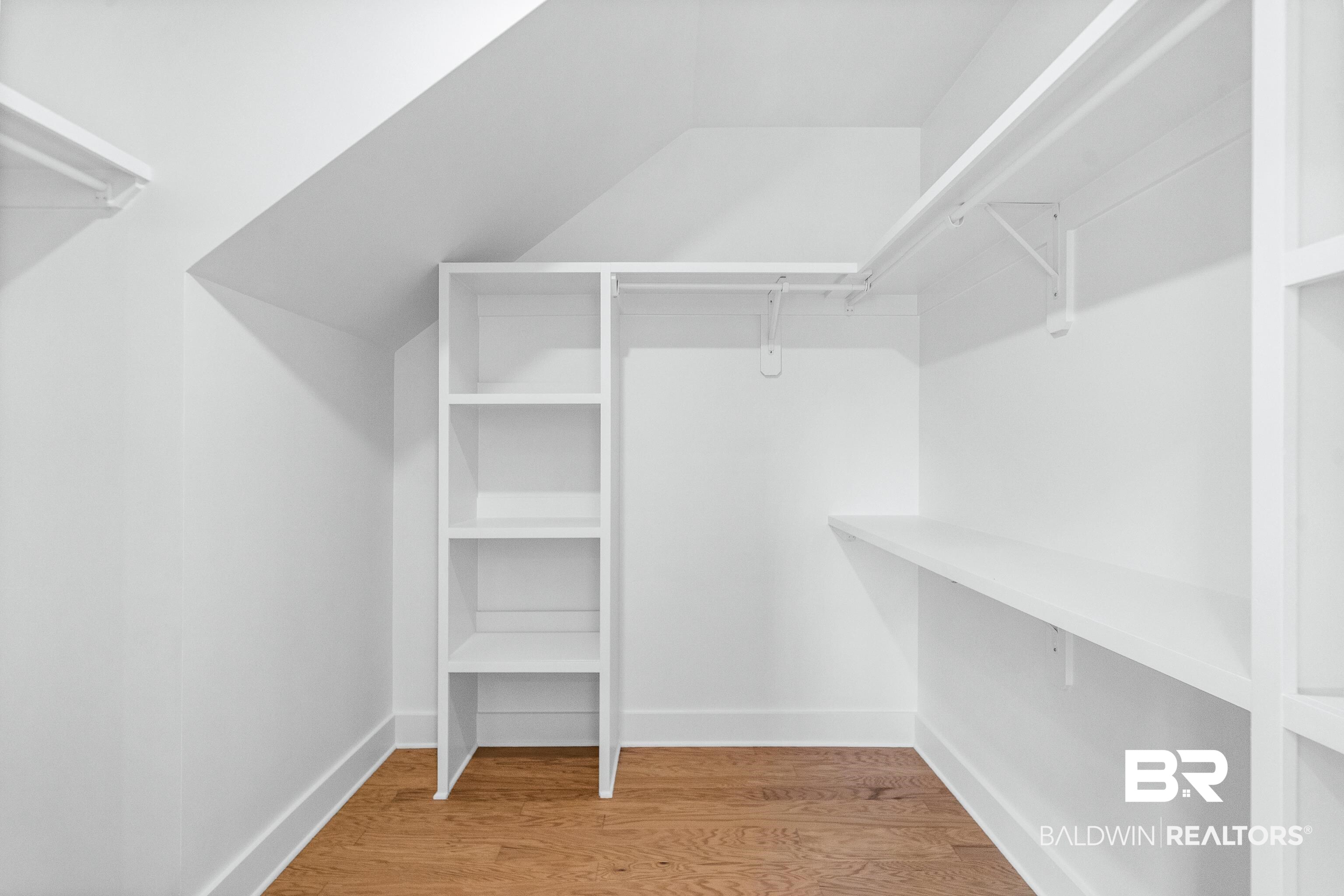25927 Capra Court Daphne, AL 36526 - Photo 21 of 37 Walk in closet with wood-type flooring