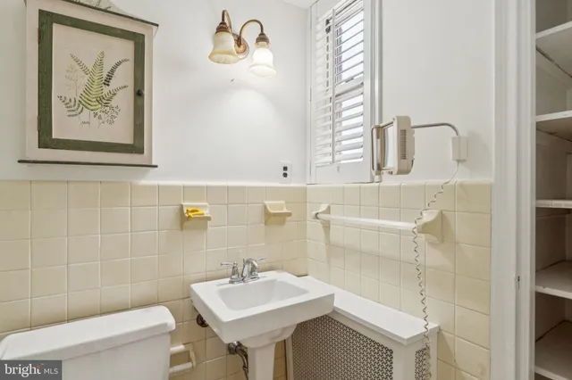 a bathroom with a sink mirror and toilet