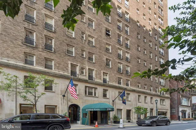 a front view of a building with parking space