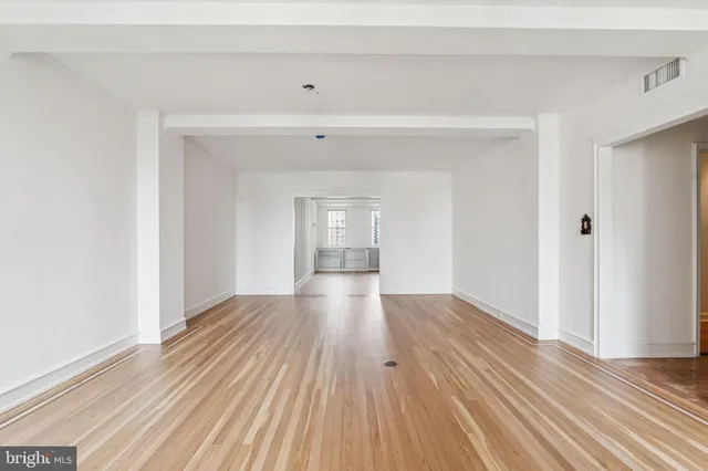 a view of wooden floor and a chandelier in a room
