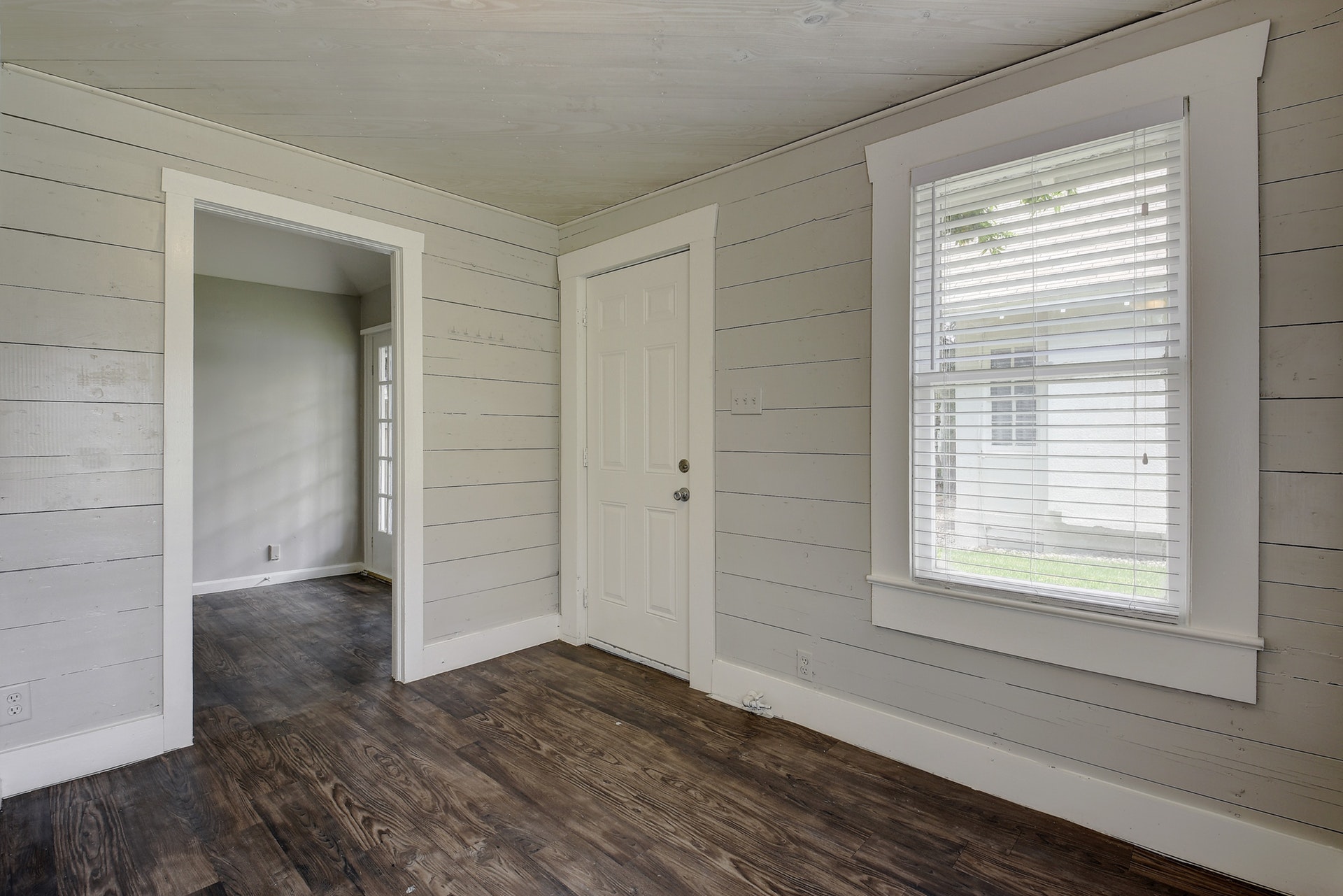 903 Shoal Cliff Court Austin, TX 78705 - Photo 14 of 32 a view of an empty room with wooden floor and a window