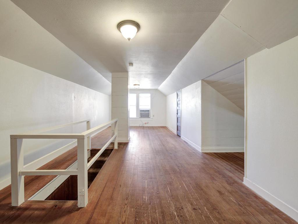 903 Shoal Cliff Court Austin, TX 78705 - Photo 18 of 32 a view of a hallway with wooden floor