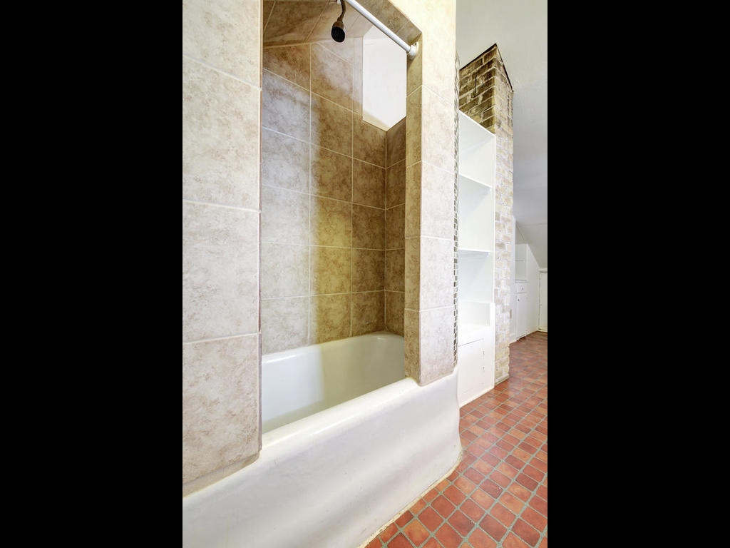 903 Shoal Cliff Court Austin, TX 78705 - Photo 22 of 32 a bathroom with a bathtub and shower