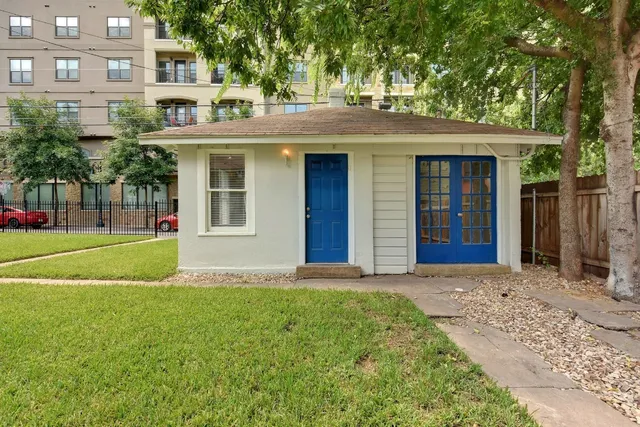 a view of a house with a yard and tree s
