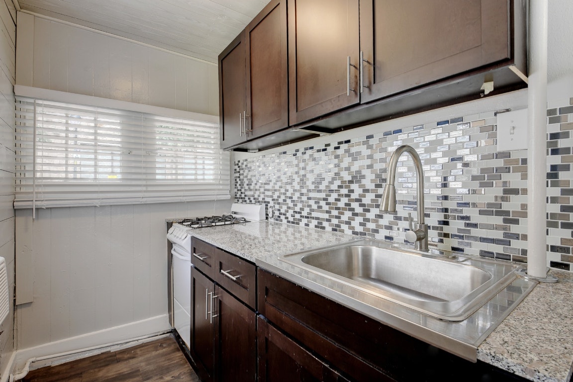 903 Shoal Cliff Court Austin, TX 78705 - Photo 25 of 32 a kitchen with a sink cabinets and window