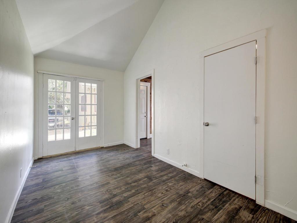 903 Shoal Cliff Court Austin, TX 78705 - Photo 27 of 32 a view of an empty room with wooden floor and a window