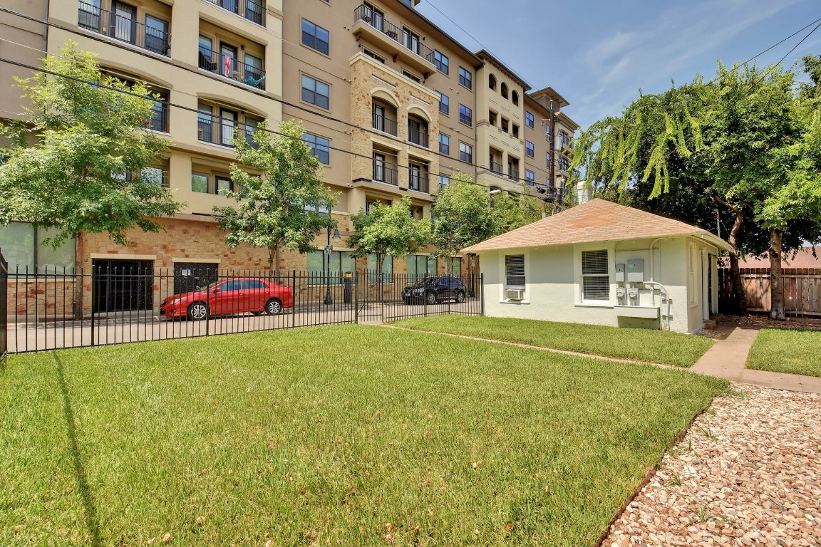 903 Shoal Cliff Court Austin, TX 78705 - Photo 29 of 32 a front view of a building with a garden