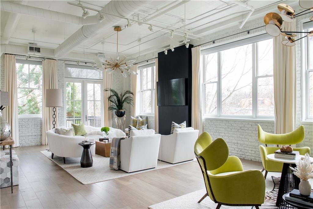3235 Roswell Road Northeast, Unit 511 Atlanta, GA 30305 - Photo 1 of 1 a living room with furniture and a chandelier