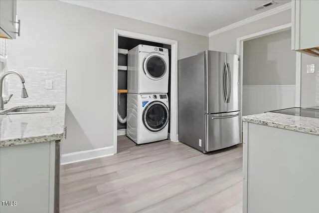 a kitchen with stainless steel appliances granite countertop a refrigerator and a sink