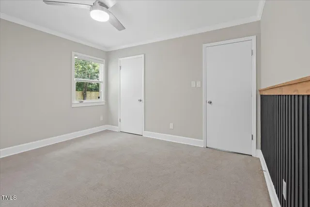 a bedroom with a bed and a potted plant
