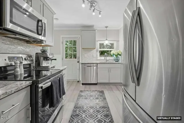 a view of a hallway with wooden floor and staircase