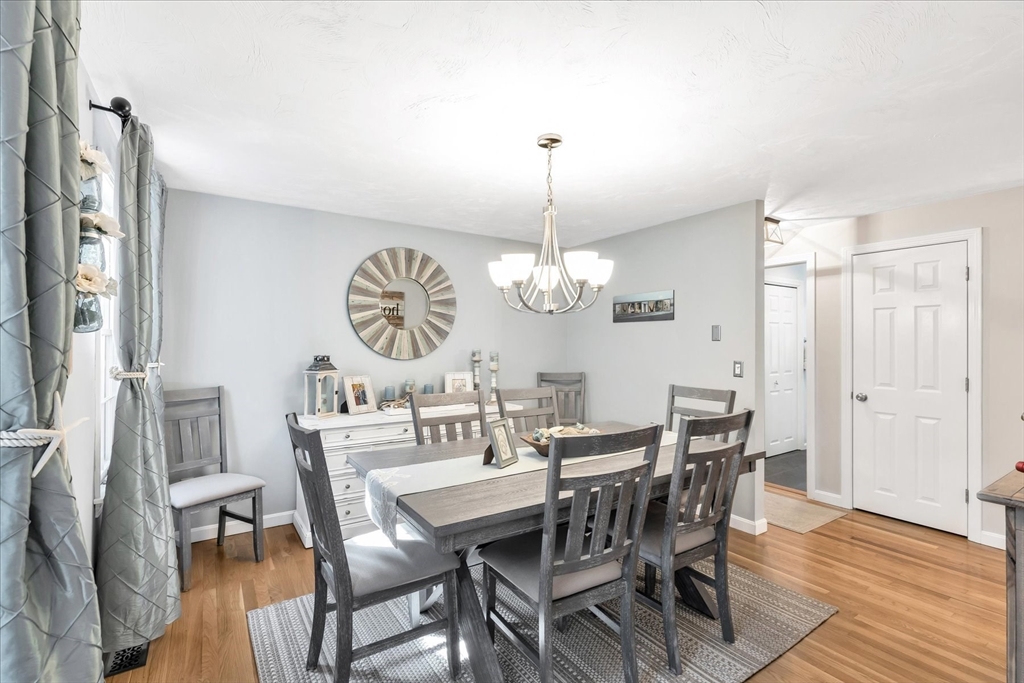 17 Wellfield Road Sandwich, MA 02644 - Photo 14 of 39 a view of a dining room with furniture a chandelier and wooden floor