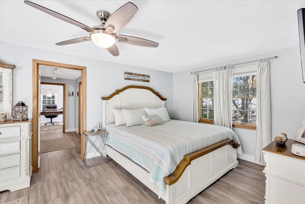 17 Wellfield Road Sandwich, MA 02644 - Photo 16 of 39 a bedroom with a large bed and a chandelier