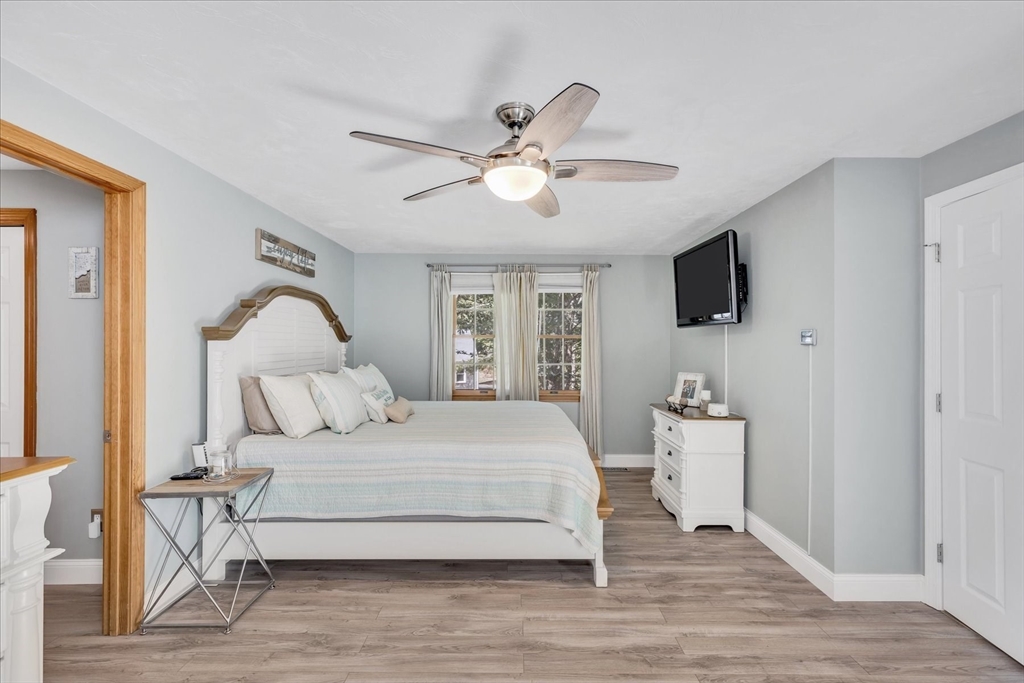 17 Wellfield Road Sandwich, MA 02644 - Photo 18 of 39 a bedroom with a bed and a chandelier