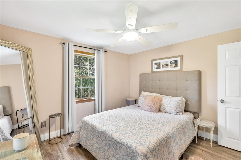 17 Wellfield Road Sandwich, MA 02644 - Photo 26 of 39 a bedroom with a large bed and a chandelier