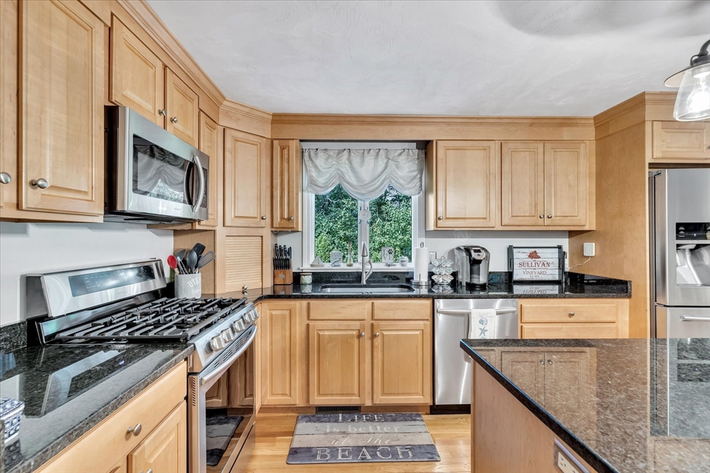 17 Wellfield Road Sandwich, MA 02644 - Photo 6 of 39 a kitchen with stainless steel appliances granite countertop a stove a sink dishwasher and microwave oven with cabinets