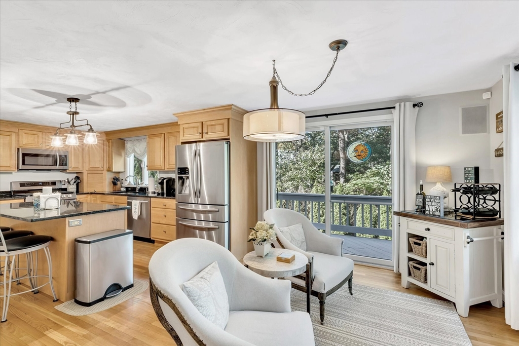 17 Wellfield Road Sandwich, MA 02644 - Photo 8 of 39 a kitchen with stainless steel appliances a dining table chairs stove and sink