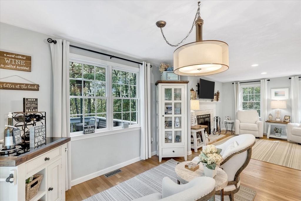 17 Wellfield Road Sandwich, MA 02644 - Photo 9 of 39 a living room with furniture a fireplace and a chandelier