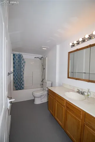 a spacious bathroom with a double vanity sink toilet mirror and bathtub