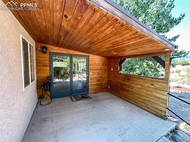 a backyard of a house with barbeque oven table and chairs