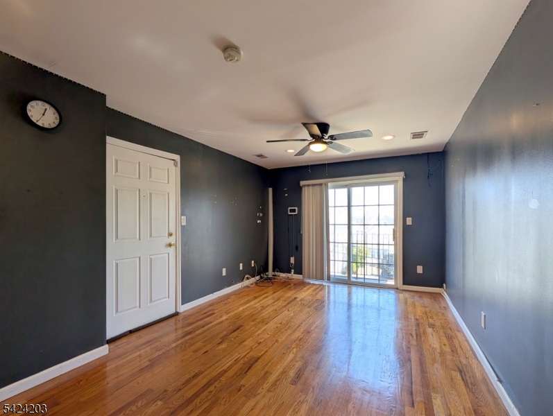 448 Fulton Street Elizabeth Port, NJ 07206 - Photo 18 of 37 a view of an empty room with wooden floor and a window