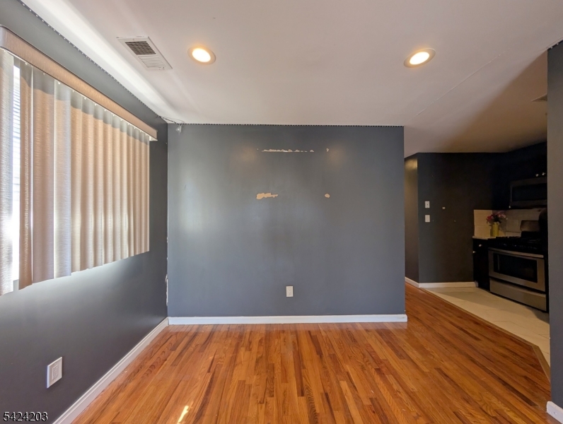 448 Fulton Street Elizabeth Port, NJ 07206 - Photo 19 of 37 wooden floor in an empty room with a window